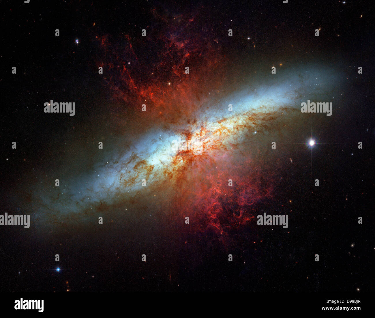 What's lighting up the Cigar Galaxy? M82, as this irregular galaxy is also known, was stirred up by a recent pass near large Stock Photo