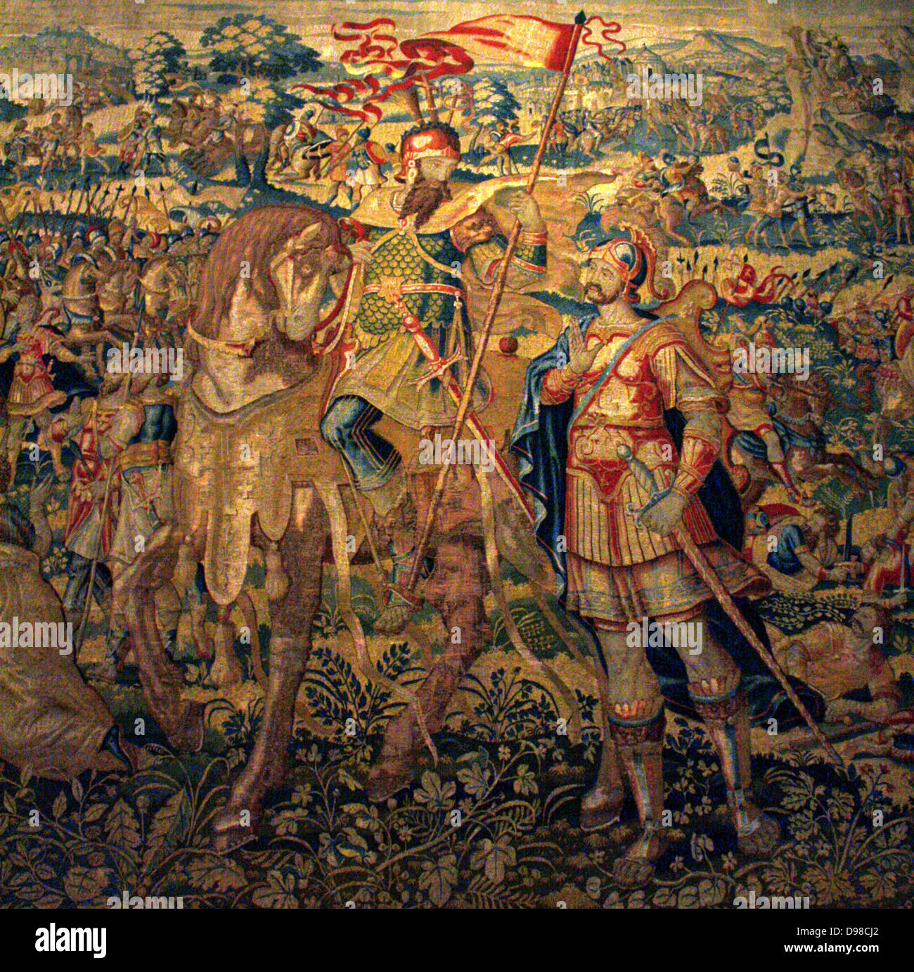 Godefroy de Bouillon.  Similar in design to the King David tapestry, this shows the crusader Godefroy de Bouillon as a victorious soldier.  Godefroy captured Jerusalem in 1099.  The heroic stories in both tapestries are depicted in a traditional manner, which adds to their magnificence. The naturalistic details in the borders are more up to date in style.  The weaver's monogram and the mark of the city of Brussels appear in the lower borders. Tapestry, between 1610-1631 Stock Photo