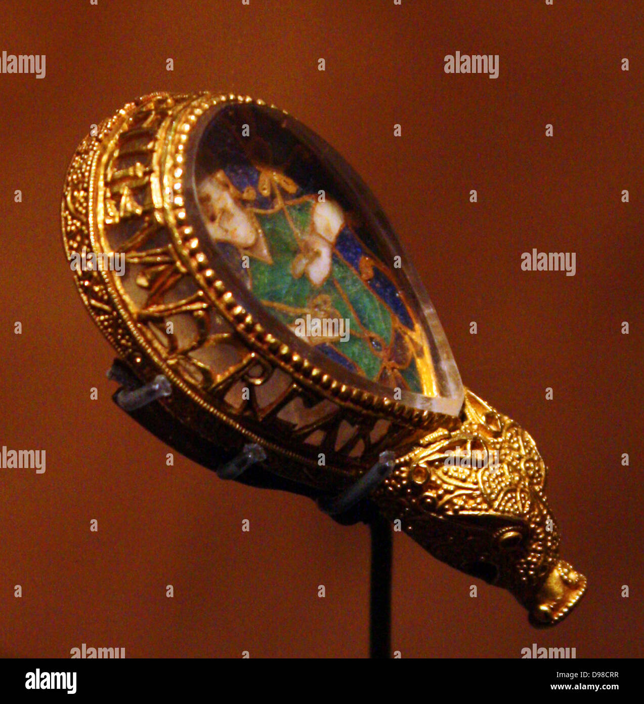 The Alfred Jewel is probably the single most famous archaeological object in England. It is comprised of a piece of cloisonne enamel depicting a human figure, though to be a representation of the sense of sight. The enamel is covered by a polished piece of rock crystal and set in a gold frame that terminates in a beast's head. Stock Photo