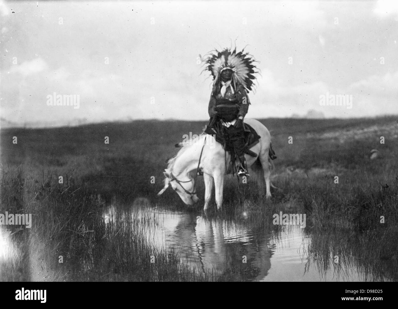 Cheyenne Indian, wearing headdress, on horseback, 1905. Photograph by Edward Curtis (1868-1952). Stock Photo