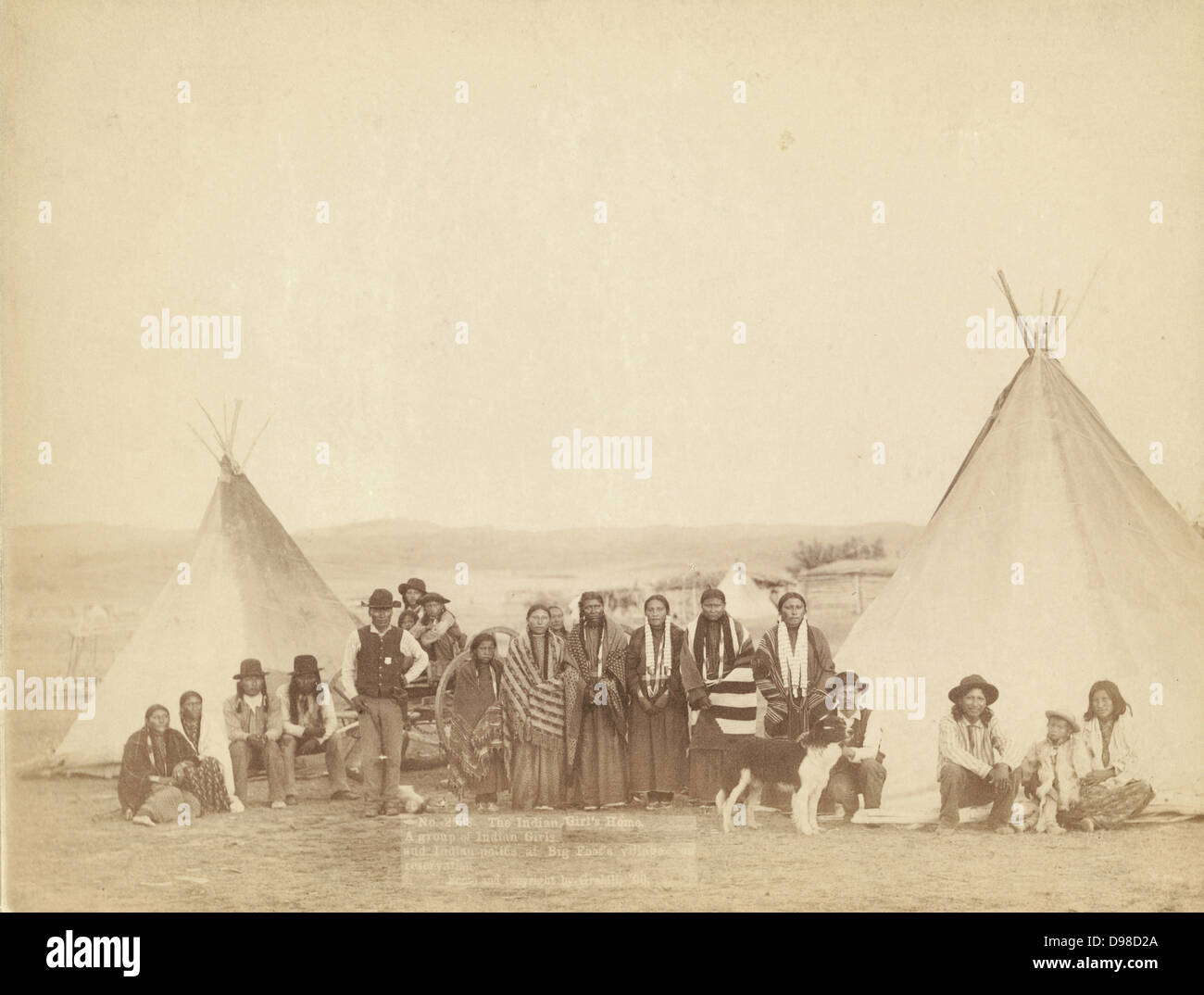 The Indian Girl's Home. A group of Indian girls and Indian police at Big Foot's village on reservation, 1900. Photograph by John C. H.Grabill (active 1887-1900). Stock Photo