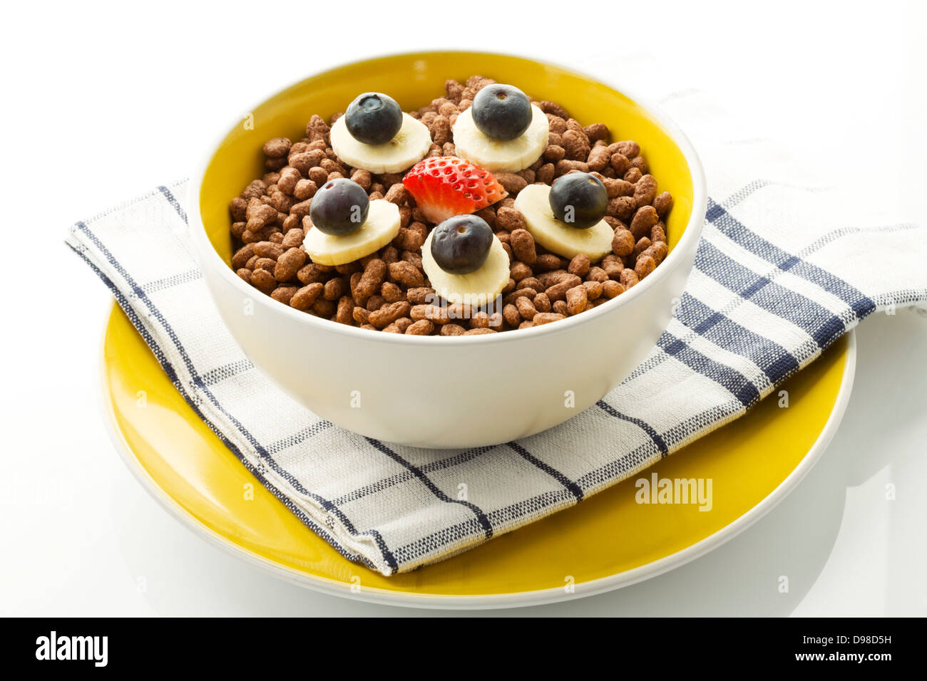 Breakfast bowl of choclate chip cereals with banana, blueberry and