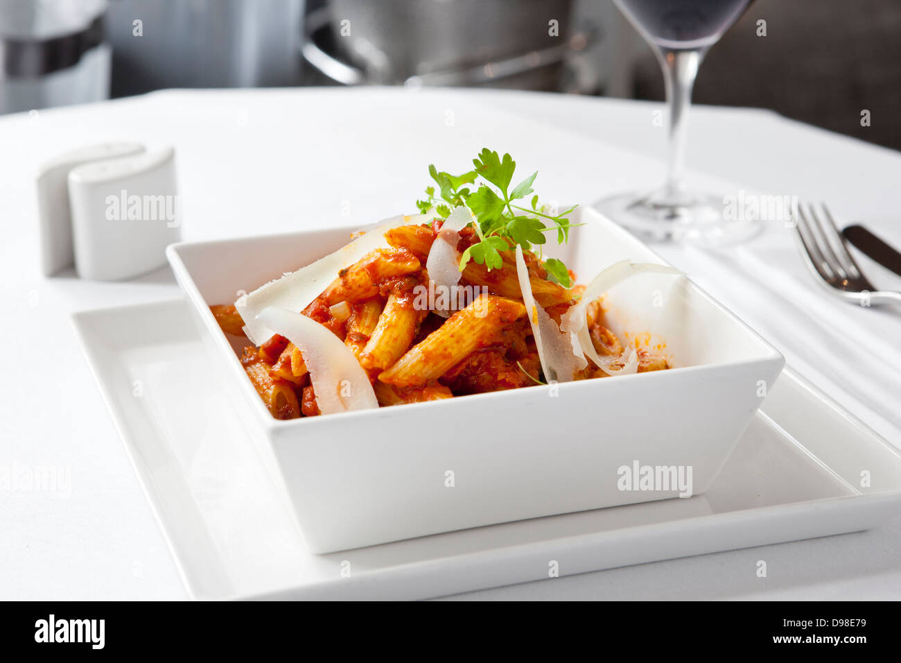 Penne Al Arrabiata with parmesan shavings Stock Photo