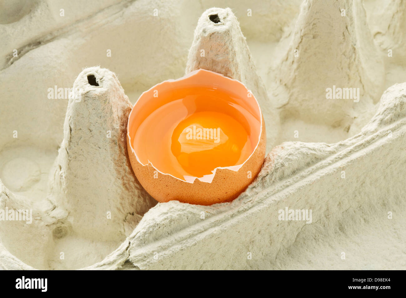 Broken egg in carton, close up Stock Photo Alamy