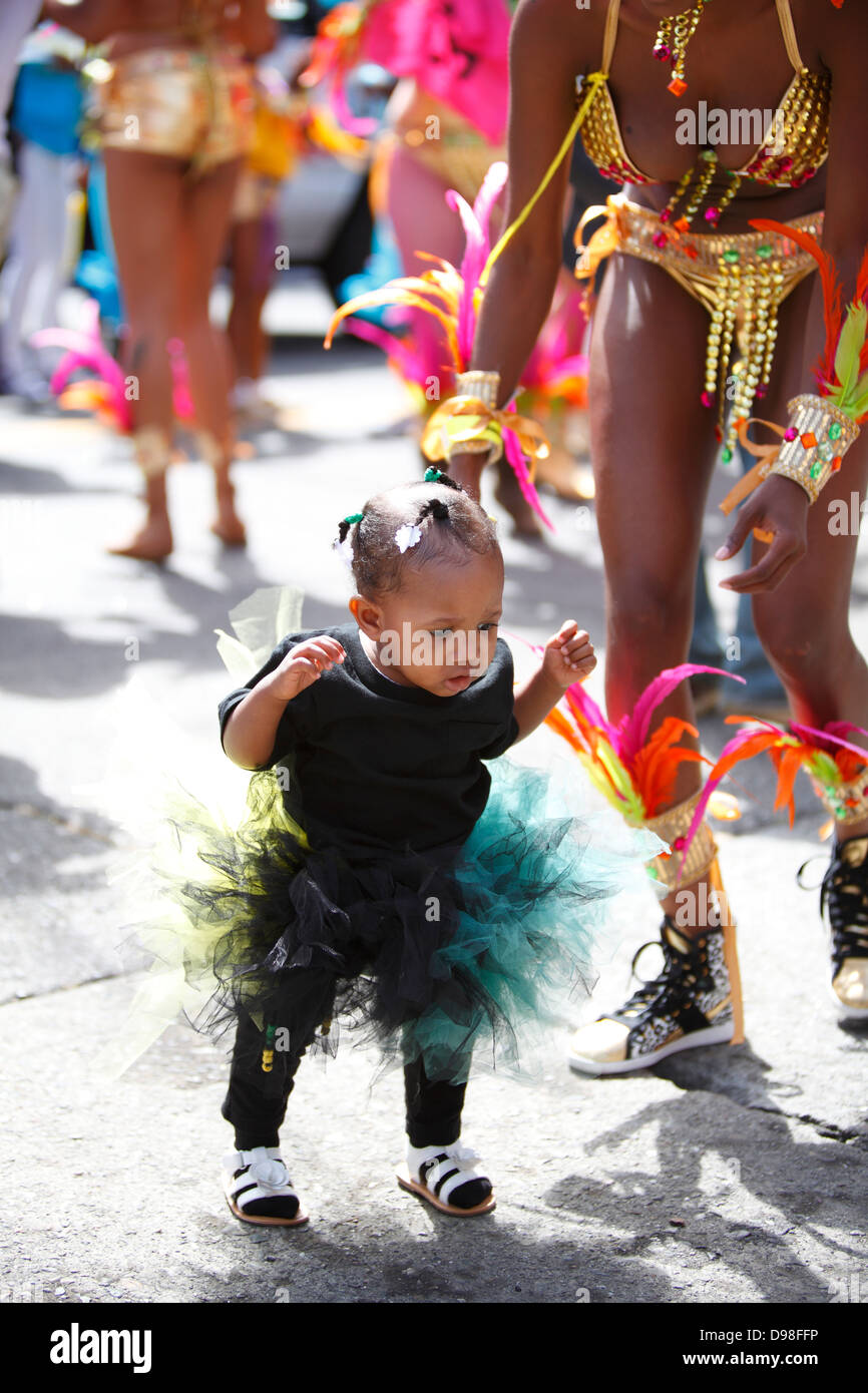 Young mother with baby during carnaval parade in Mission District, San Francisco, California, USA Stock Photo
