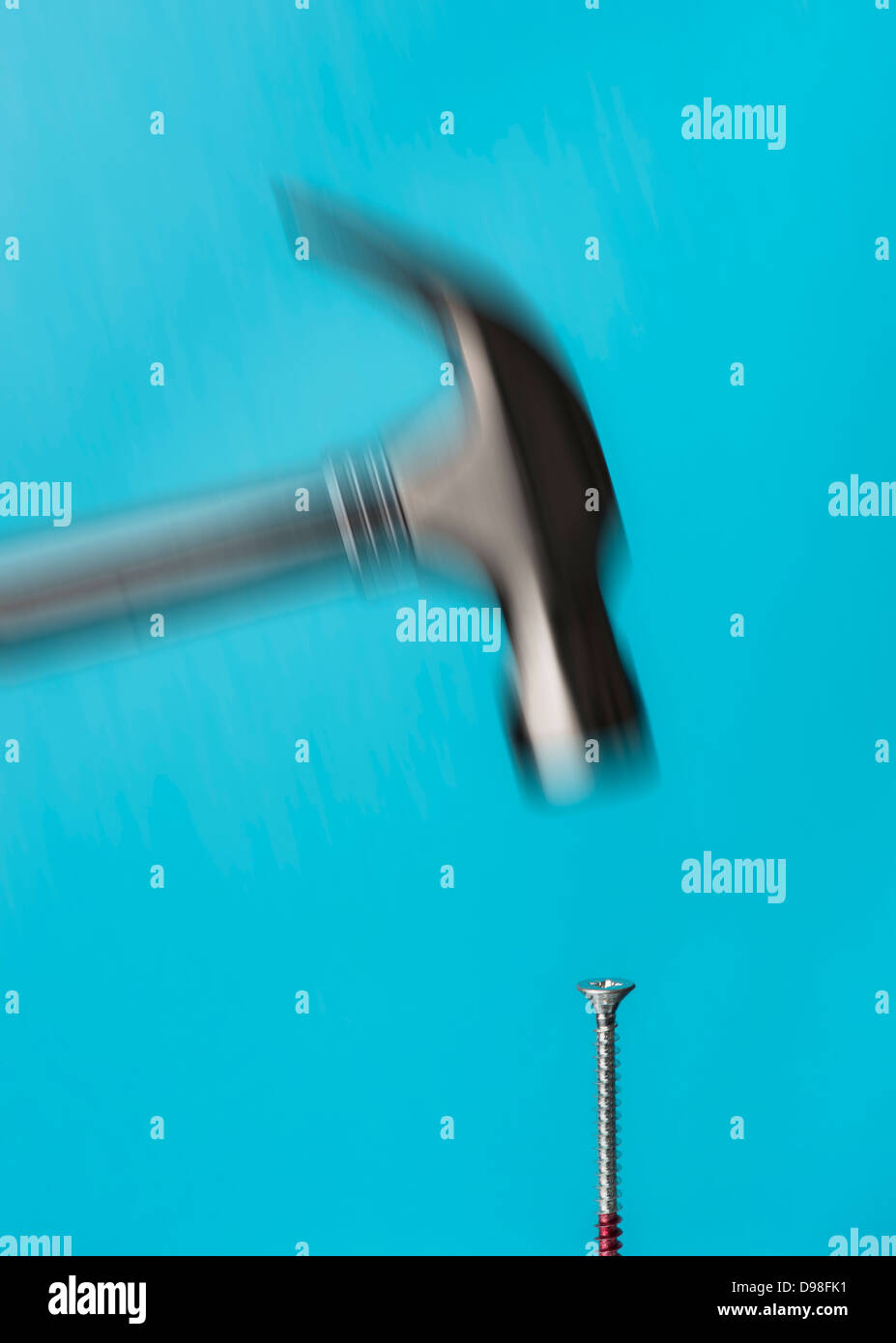 Blurred motion of hammer hitting a screw Stock Photo