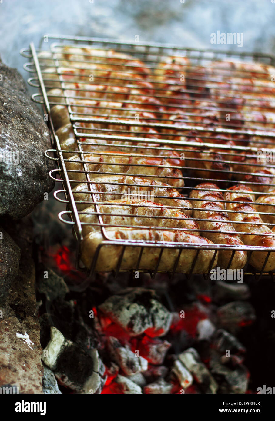 appetizing yummy german sausages on the barbecue grill on open fire Stock Photo