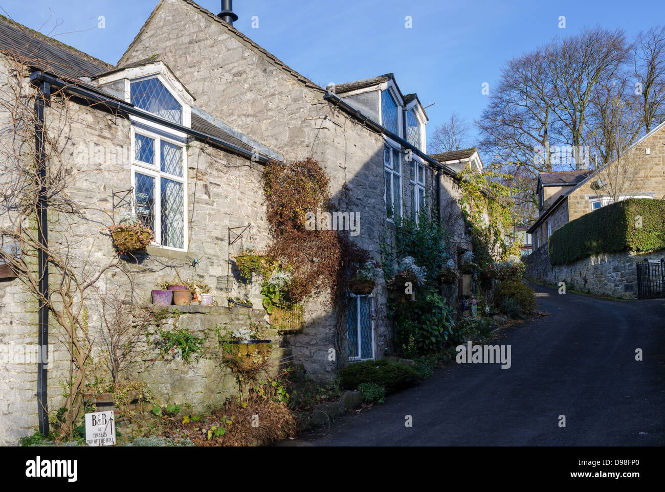 Traditional stone-built cottages in the pretty Peak District village of Great Longstone Stock Photo