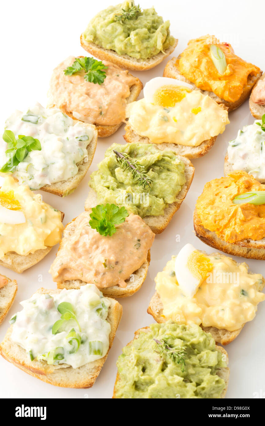 Variety of spreads with tuna, egg, tomato, mozarella, ham, green onions