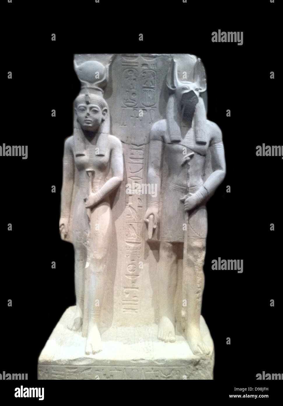 Limestone statue representing Isis and epwawet. 19th Dynasty, reign of Ramses II circa 1279-1213 BC. Isis was the patron goddess of the Royal scribe Siaset, who commissioned this statue. Wepwawet was the god of the Town of Assiut where it was made. Stock Photo