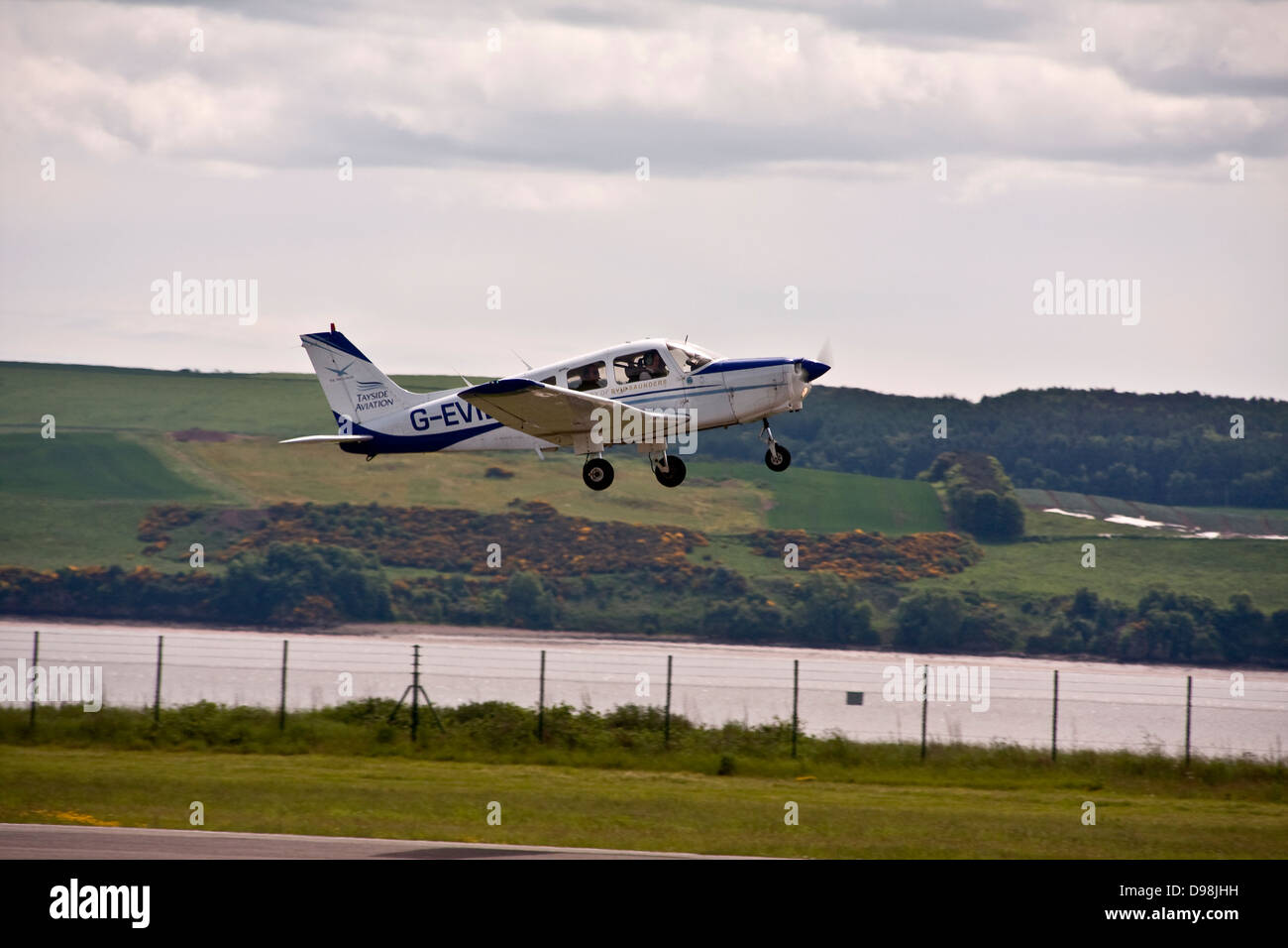 The Tayside Aviation Piper PA-28 Warrior G-EVIE light monoplane taking off from Dundee airport, UK Stock Photo