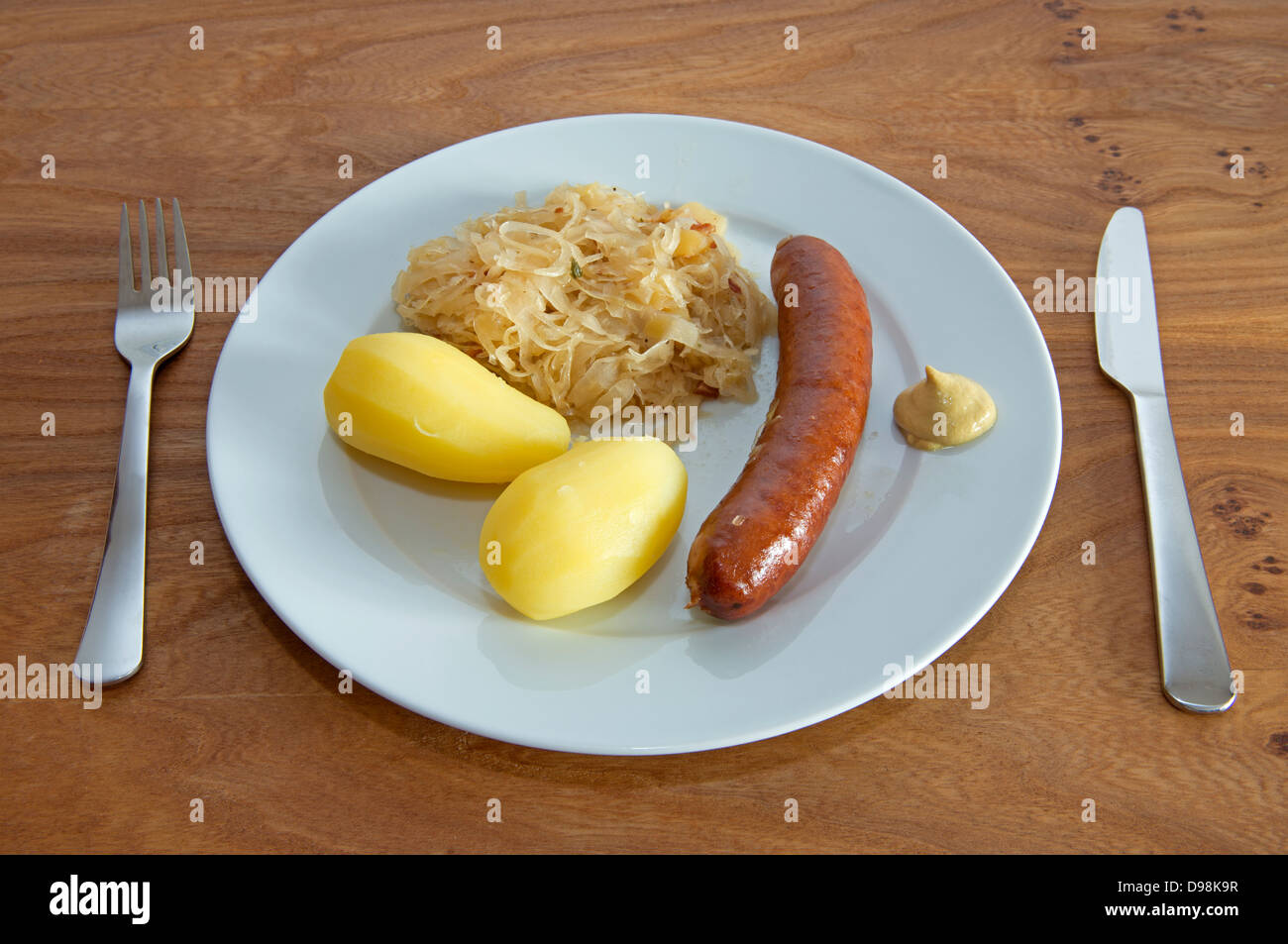 Sauerkraut, pork sausage, boiled potatoes. Stock Photo