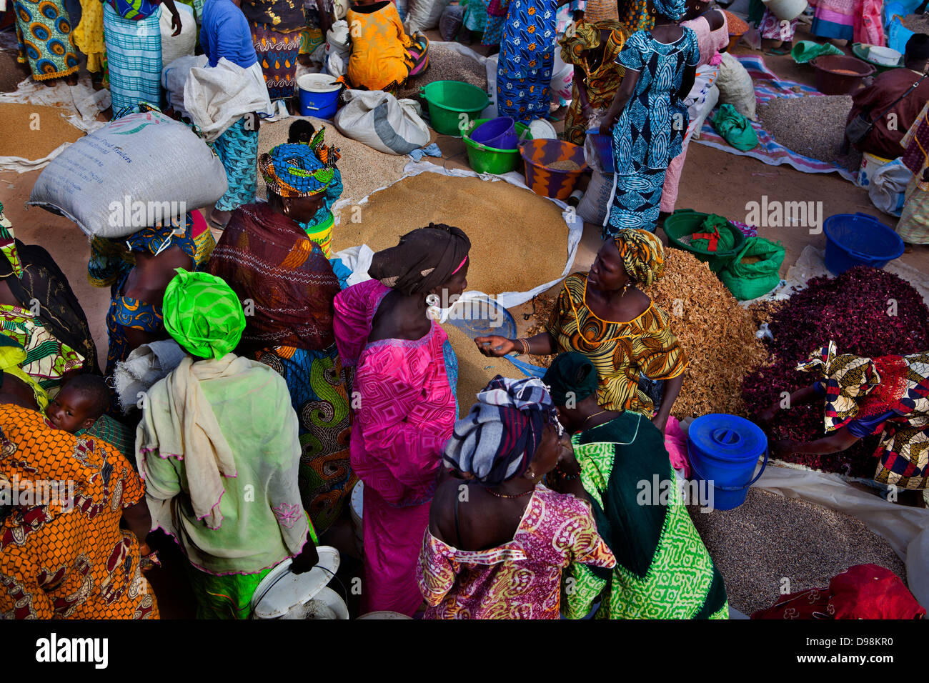 Women buying and selling in a traditional bush market in the village of Mbaye Faye, Senegal Stock Photo