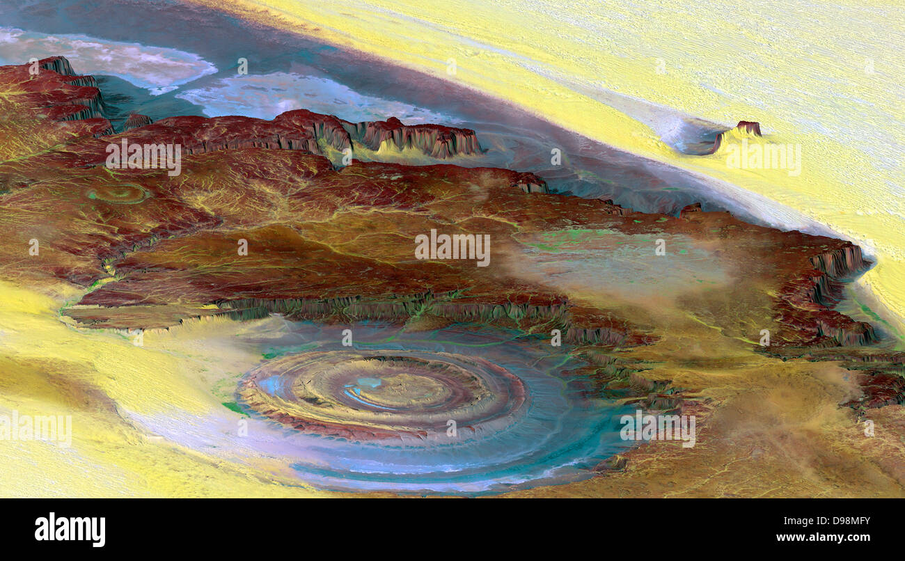 This prominent circular feature, known as the Richat Structure, in the Sahara desert of Mauritania is often noted by astronauts because it forms a conspicuous 50-kilometer-wide (30-mile-wide) bull's-eye on the otherwise rather featureless expanse of the desert. Initially mistaken for a possible impact crater, it is now known to be an eroded circular anticline (structural dome) of layered sedimentary rocks. This view was generated from a Landsat satellite image draped over an elevation model produced by the Shuttle Radar Topography Mission (SRTM).  taken in 2000. Stock Photo