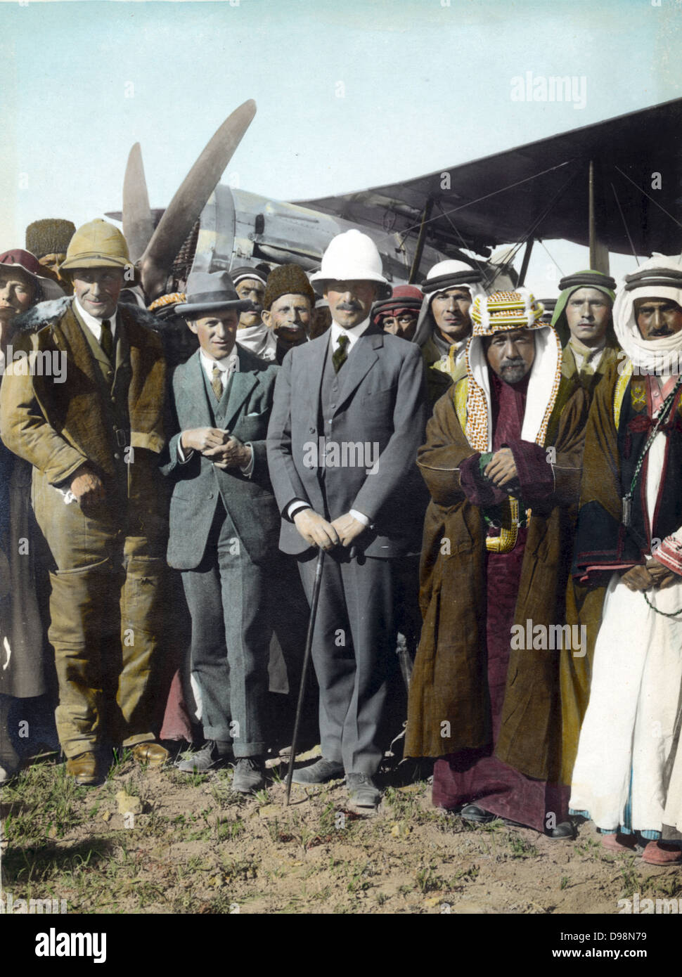On the airfield at Amman, Jordan, April 1921: T E Lawrence, Sir Herbert Samuel (British High Commissioner of Palestine), Emir Abdullah. Woman far left, possibly Gertrude Bell. Sheik Majid Pasha el Adwan, far right. Stock Photo