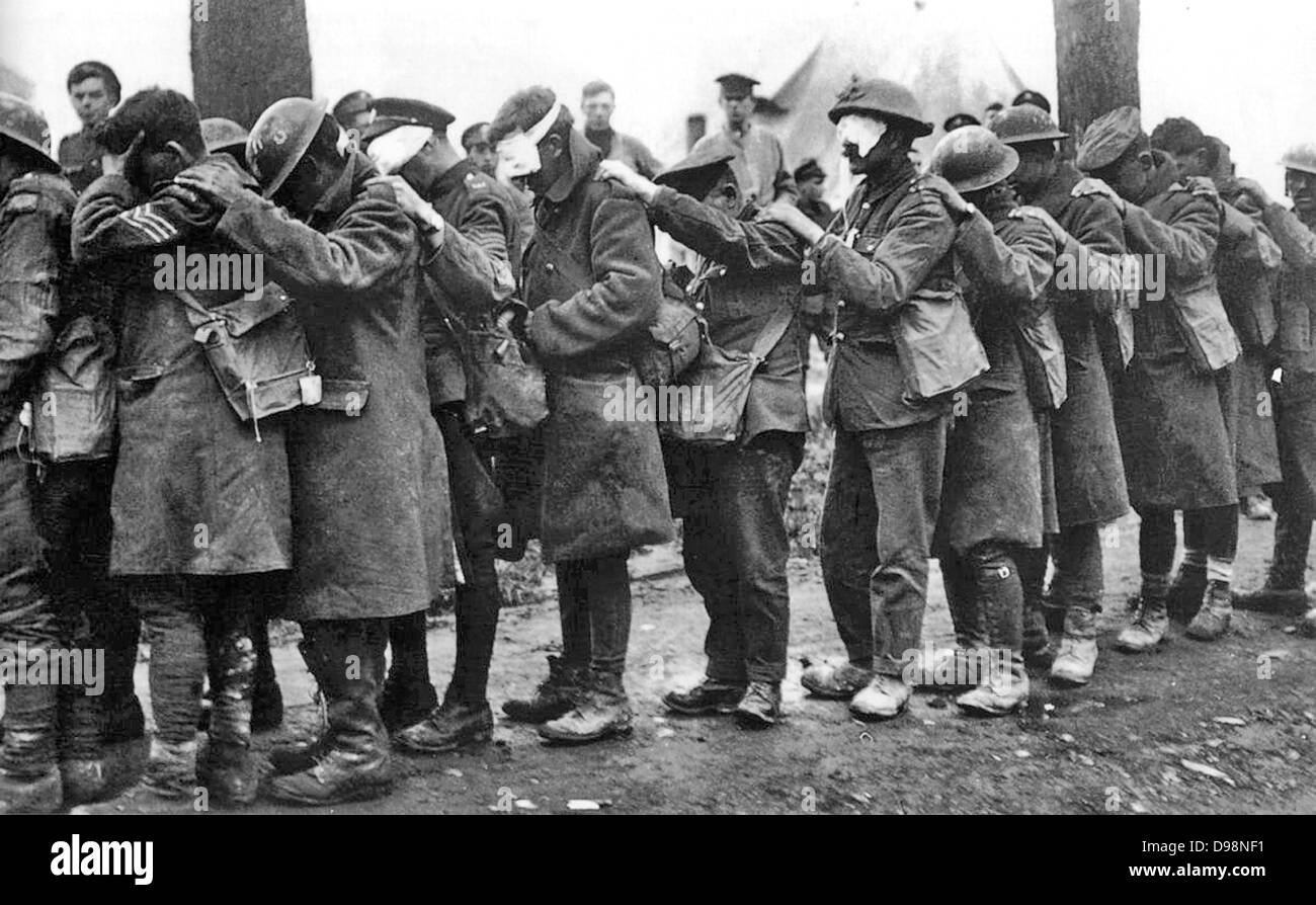 World War I 1914-1918: The blind leading the blind. Men of the 55th British Division, casualties of a poison gas attack walking in single file with hand on shoulder of man in front, 10 April 1918. Chemical Warfare Military Soldier Stock Photo