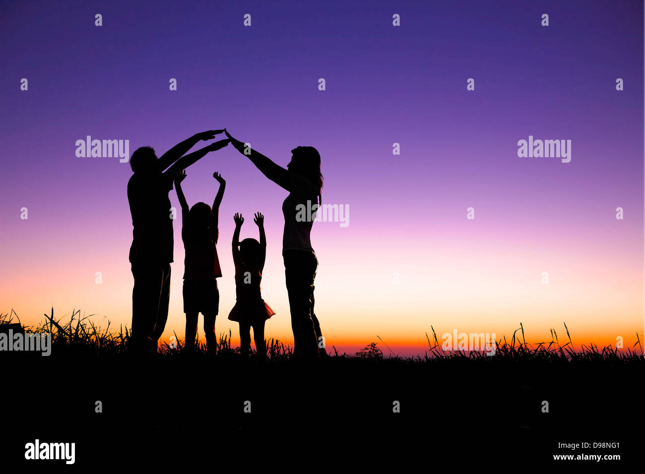 happy family making the home sign on the hill Stock Photo
