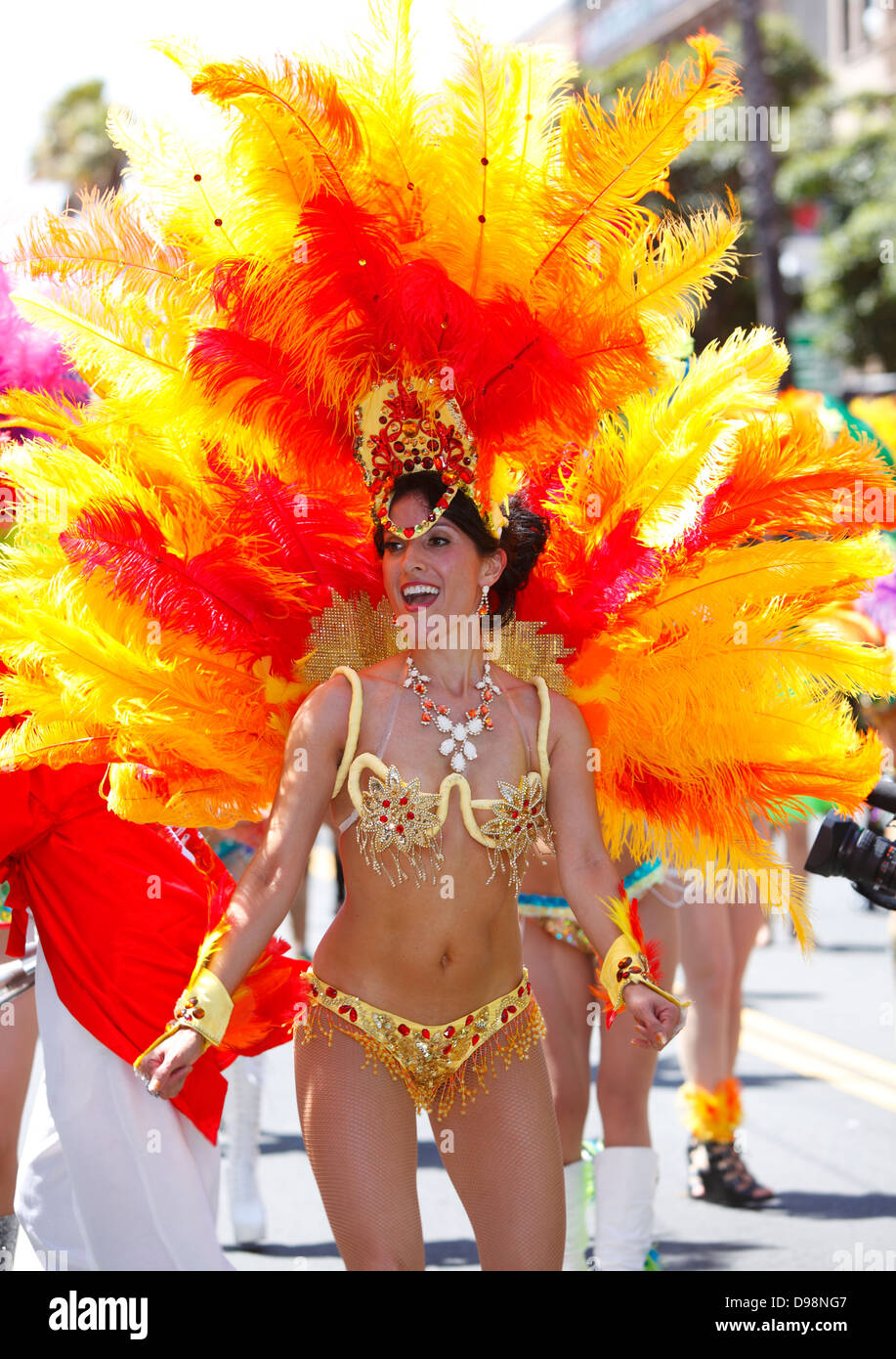 Colorful dancer with feathers at carnaval parade in Mission District, San Francisco, California, USA Stock Photo