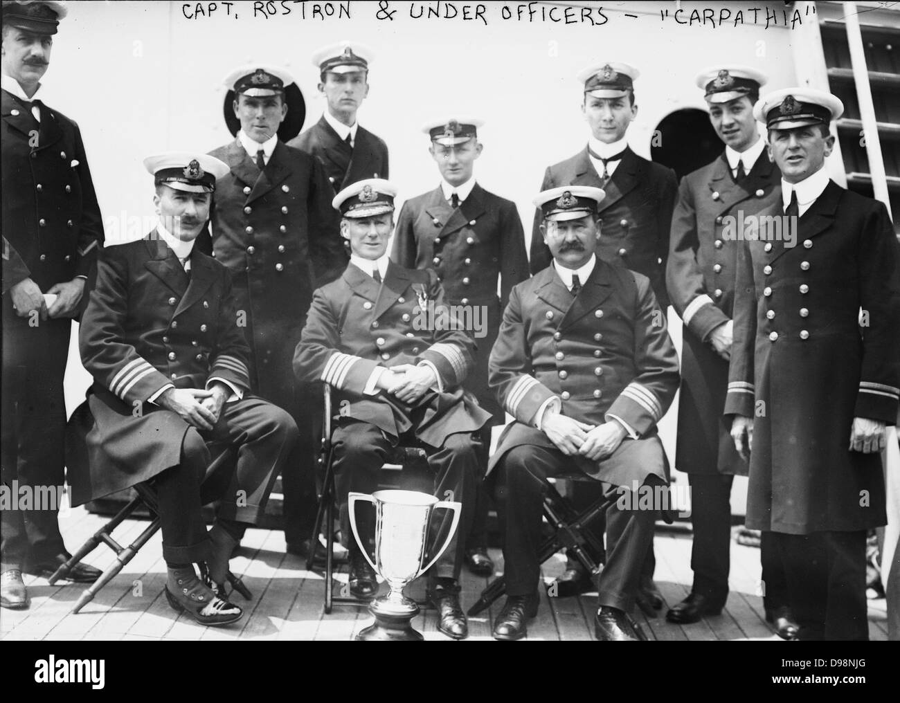 Captain Arthur Rostron and under officers of RMS Carpathia (Cunard), with loving cup presented to him by survivors of wreck of RMS Titanic (White Star Line), 12 April 1912 in recognition of his heroism in the rescue. Shipwreck Disaster Stock Photo