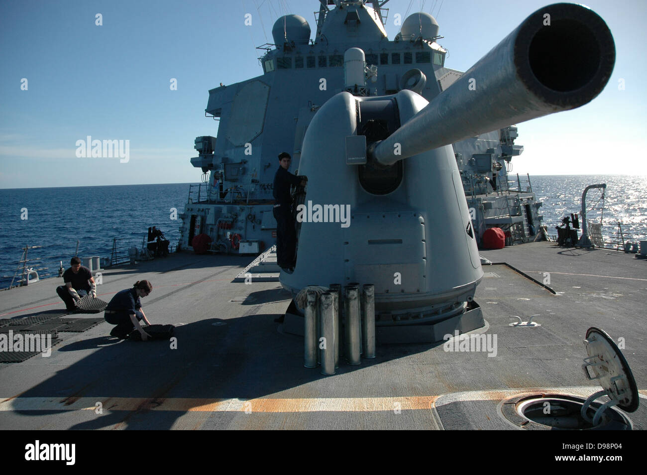 GULF OF THAILAND (June 8, 2013) Sailors assigned to the weapons department aboard the guided-missile destroyer USS Curtis Wilbur (DDG 54) position the ship’s 5-inch gun and clear the deck after a live-fire exercise during the at-sea phase of exercise Coop Stock Photo