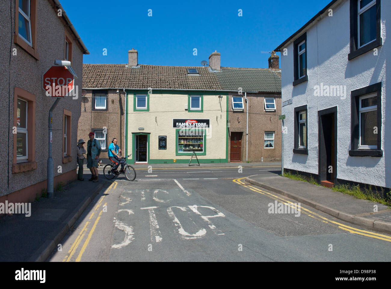 Two walkers and cyclist in the village of Cleator, West Cumbria
