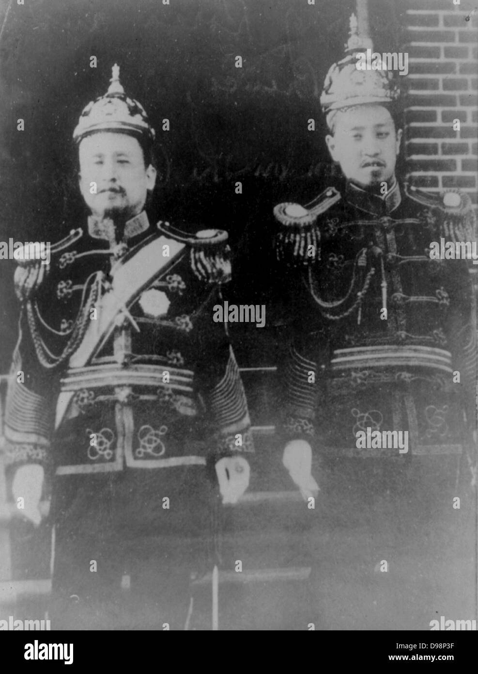 Kojong, Emperor of Korea (1852-1919) and the Crown Prince Yi Wang. Emperor and prince in uniform, standing and facing forwards. Stock Photo