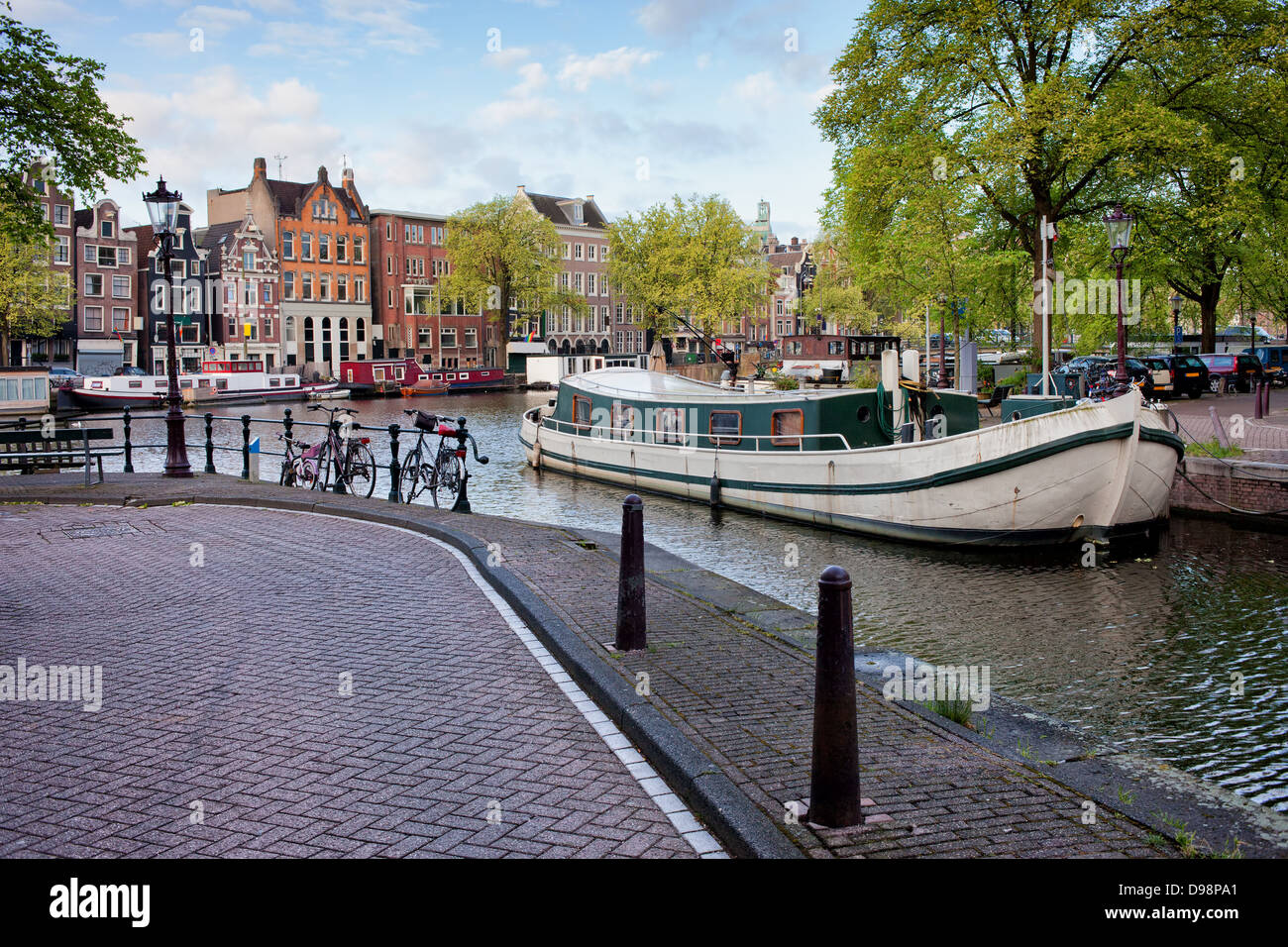 City of Amsterdam cityscape, houseboats on Groenburgwal canal and Amstel river, Netherlands, North Holland province. Stock Photo