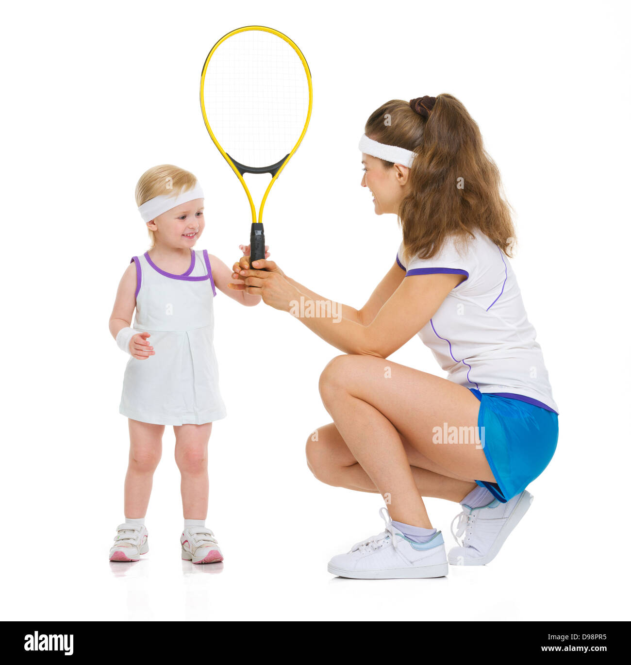 Mother giving baby tennis racket Stock Photo Alamy