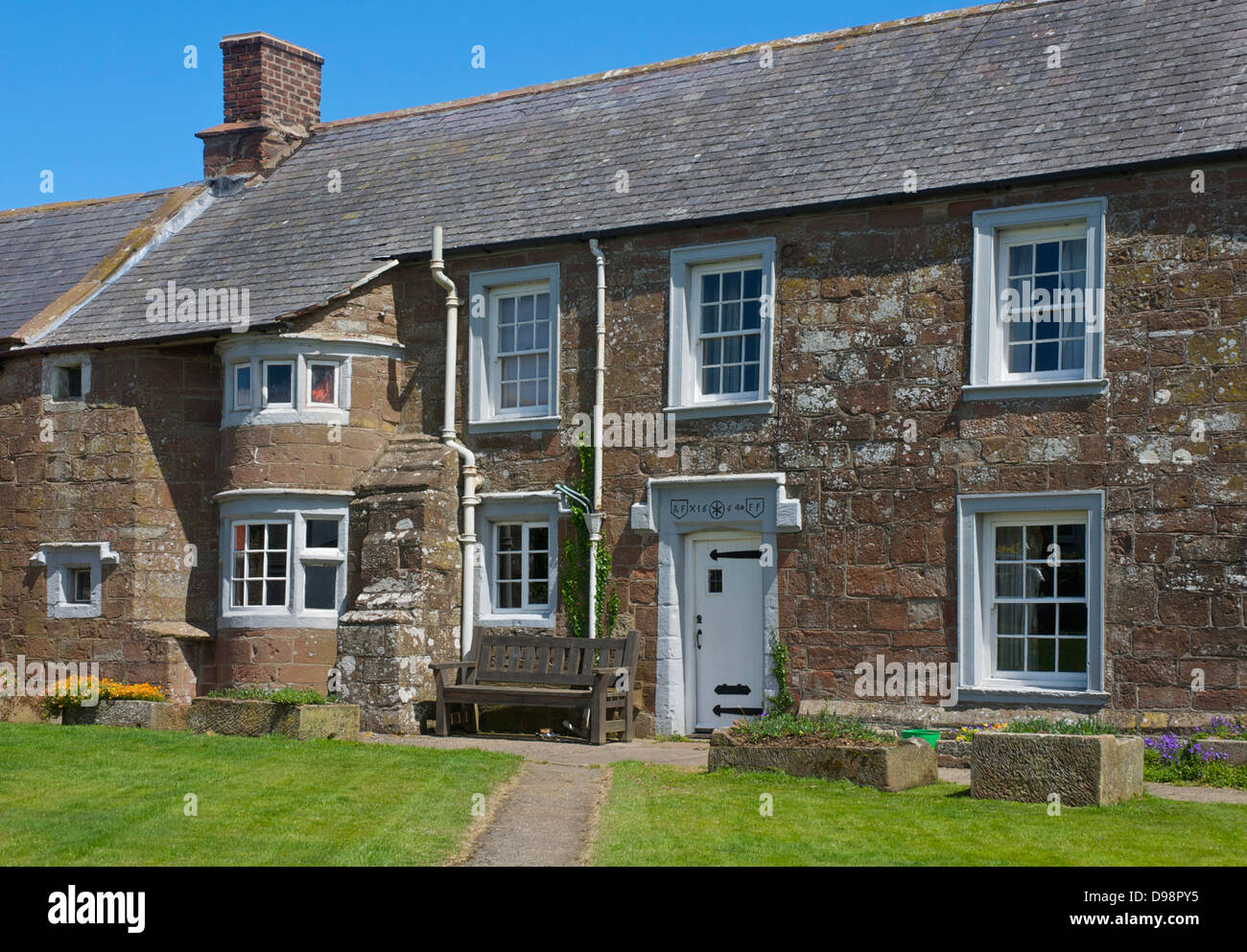 Sandstone house with a datestone of 1664, in the village of Abbeystead, Northern Cumbria, England UK Stock Photo