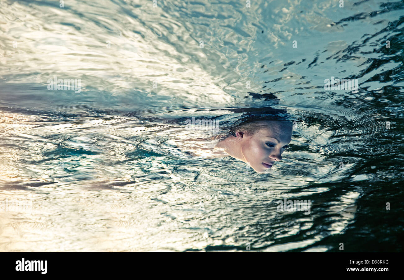 Woman floating in water Stock Photo