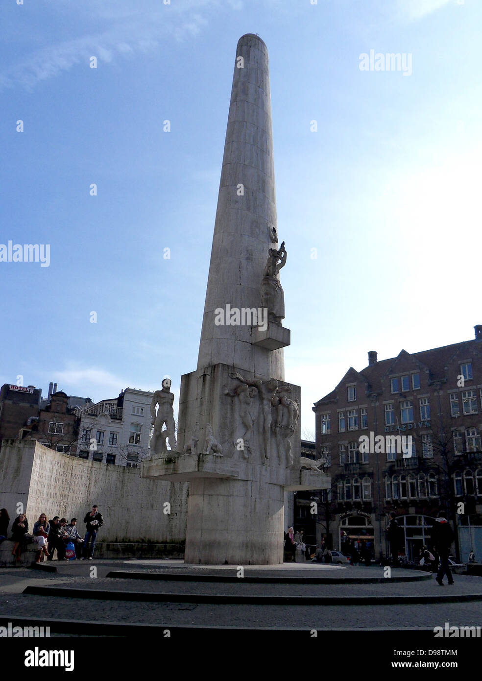 Dam Square, or simply the Dam (Dutch: de Dam) is a town square in Amsterdam, the capital of the Netherlands. The National Monument (Dutch: Nationaal Monument or Nationaal Monument op de Dam) is a 1956 World War II monument on Dam Square in Amsterdam. Stock Photo