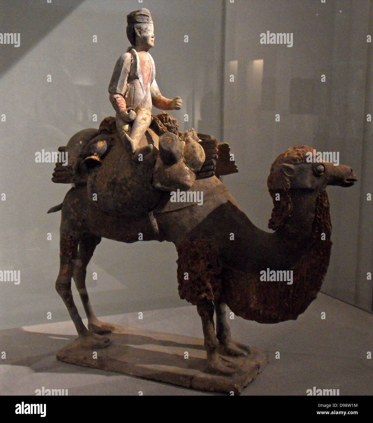 Chinese figurine of a Bactrian Camel with rider. Sui dynasty (581-618 AD), Tang dynasty (618-907 AD) polychrome terracotta. Stock Photo