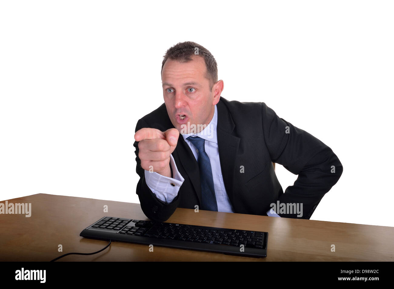 Image of a businessman pointing across a desk Stock Photo
