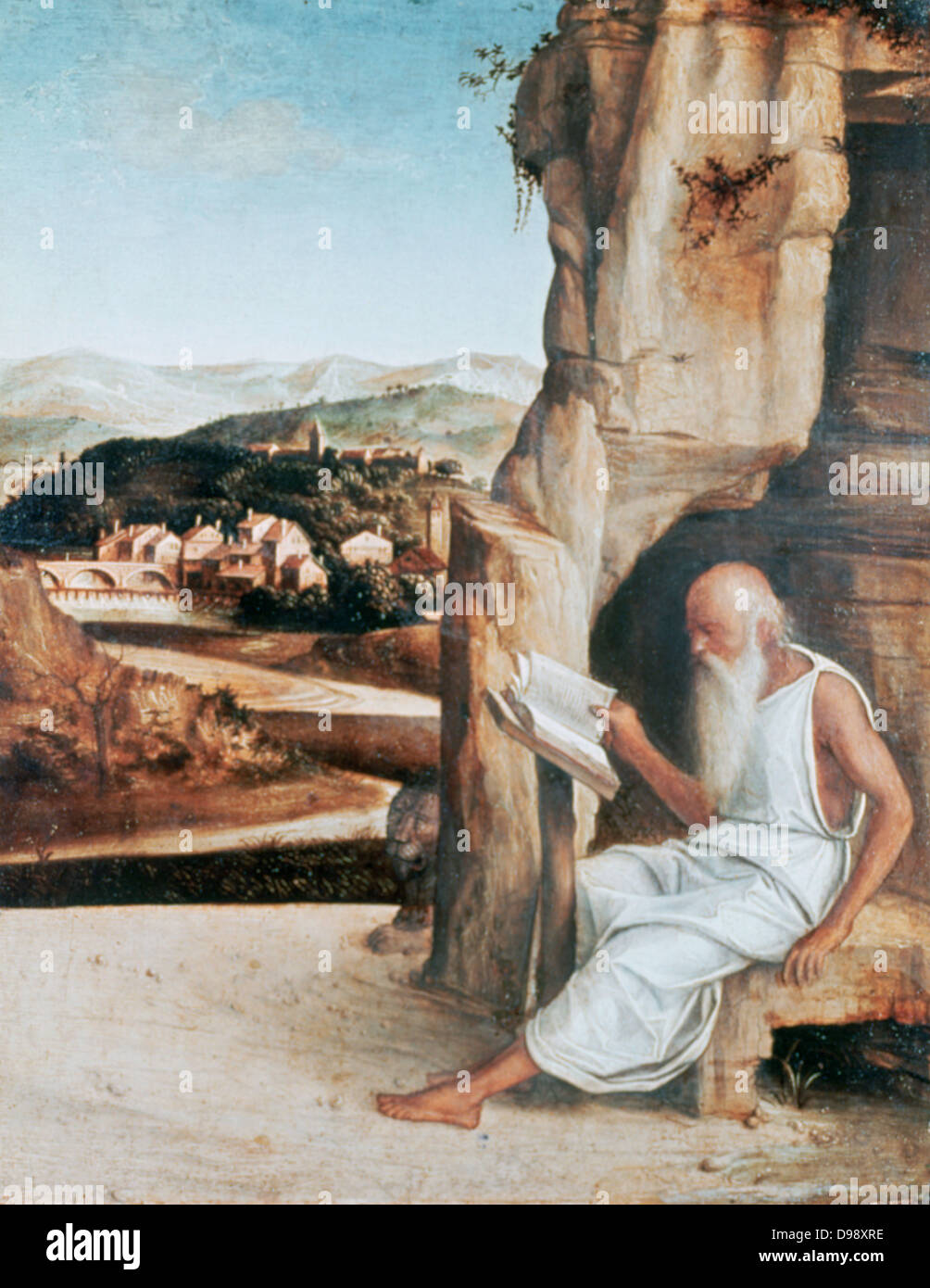 St Jerome in the Desert' attributed to Giovanni Bellini (1426-1516) Italian painter. Jerome (c340-420) a father of Western Christian Church and compiler of the Vulgate reading, his lion centre. Book Beard Cave Old Aged Hermit Stock Photo