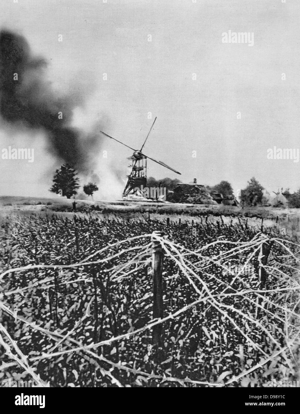 World War I 1914-1918: Windmill destroyed by German shellfire. Barbed wire defences in foreground. France World War I. From 'Le Flambeau', Paris, September 1915. Stock Photo
