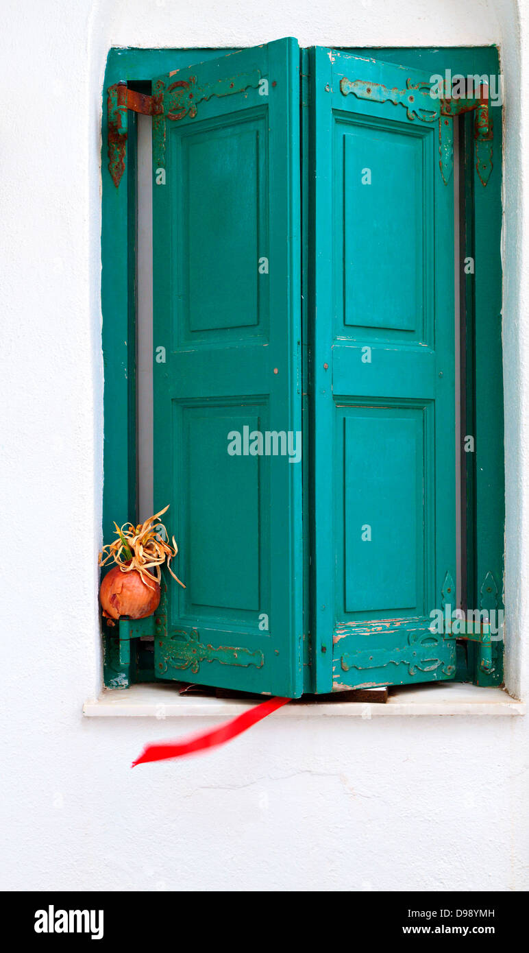 Traditional window with wooden shutters at Mykonos island in Greece Stock Photo