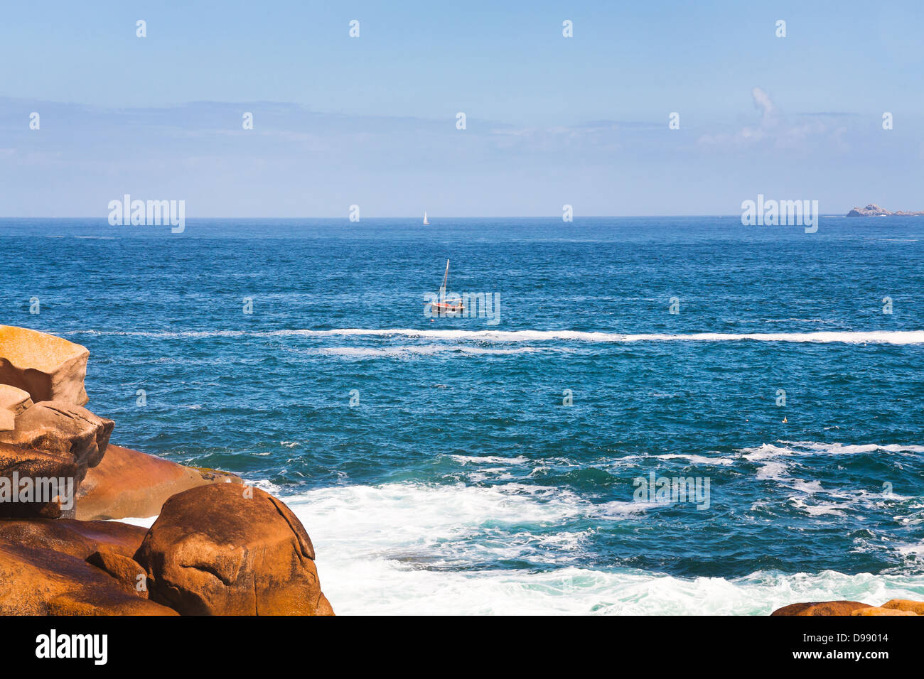 boat near Pink Granite Coast in Brittany in sunny day, France Stock Photo