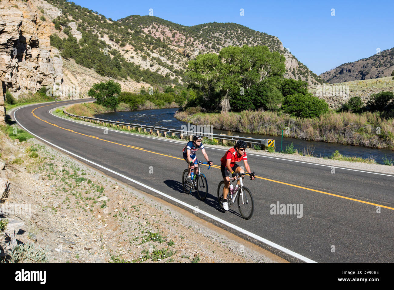Cyclists riding the annual Ride The Rockies bicycle tour, Highway 50, Arkansas River, south of Salida, Colorado, USA Stock Photo