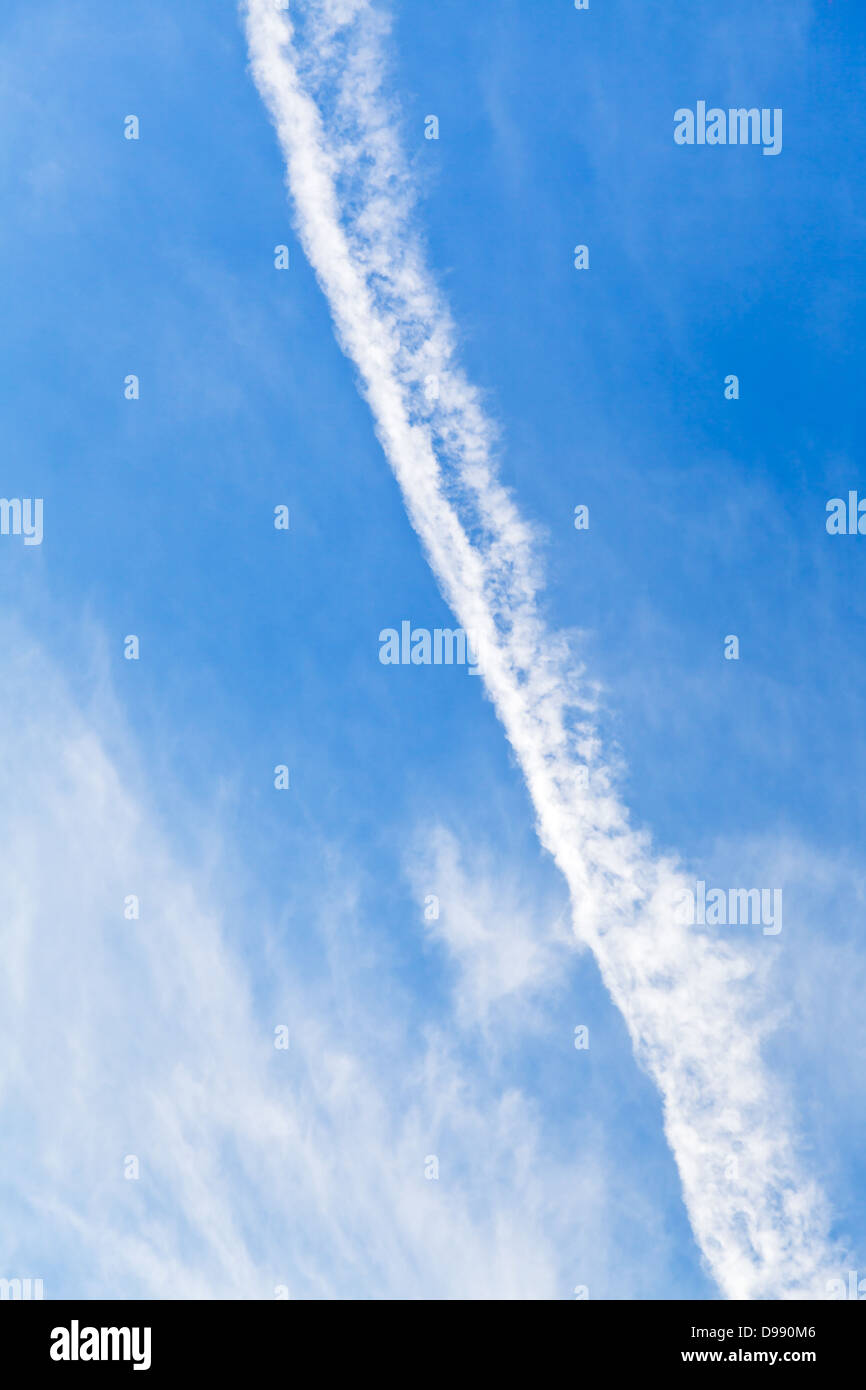 Cloud trace of plane in blue sky Stock Photo