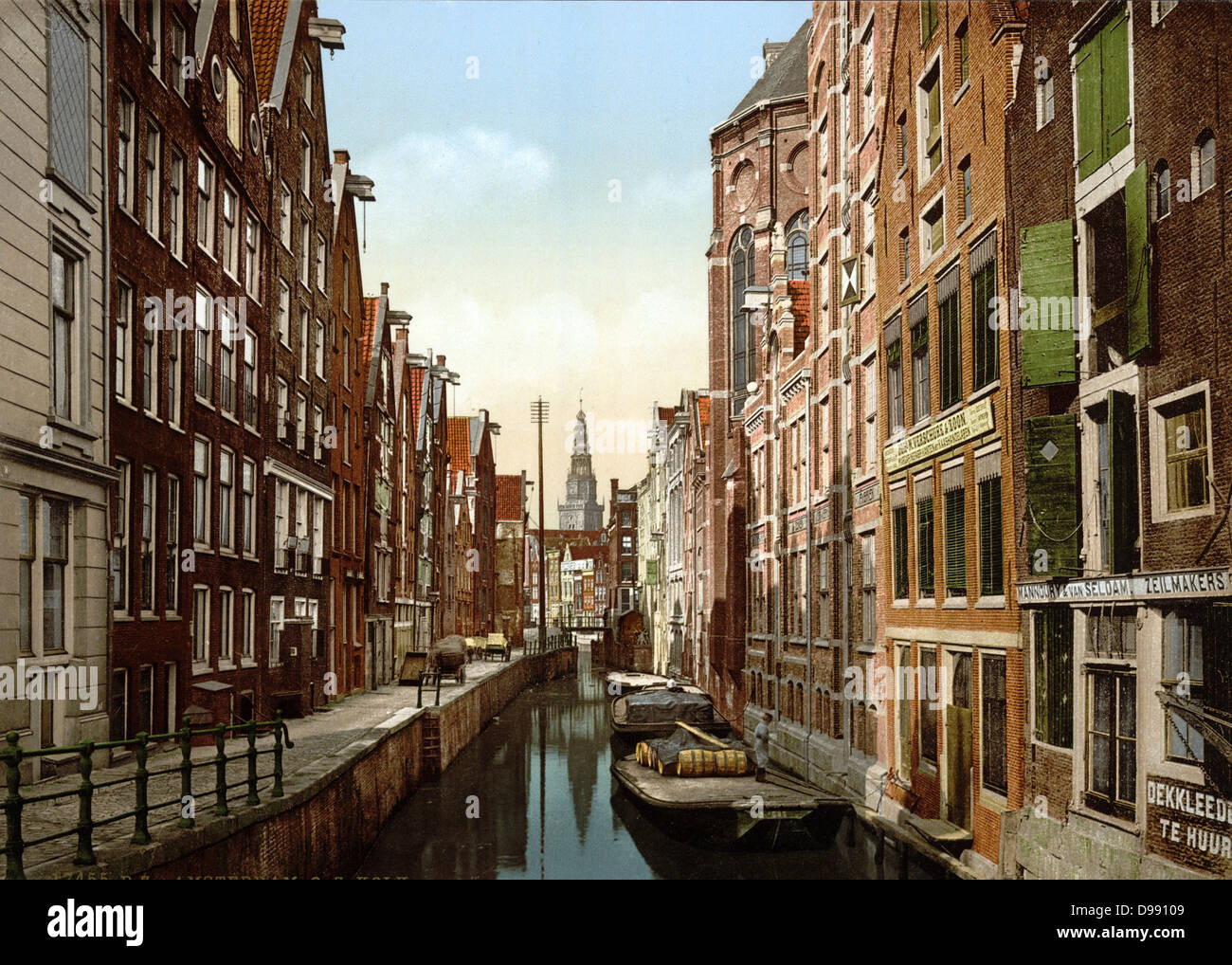 Oude Zÿds, the Kolk , Amsterdam, Holland, 1890-1900. View of canal in the old Jewish quarter, with flat-bottomed punts or barges on the water and hand carts on the pavement. Netherlands Transport Architecture Stock Photo