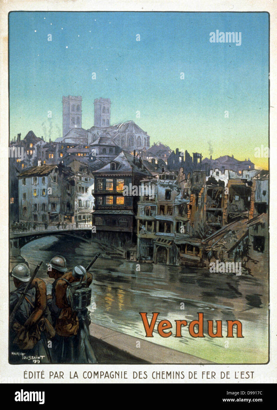 French soldiers marching beside a river and over a bridge into a shelled Verdun. The battle of Verdun in 1916 was the longest and costliest battle World War I. From publication sponsored by a French railway company, 1919. Stock Photo