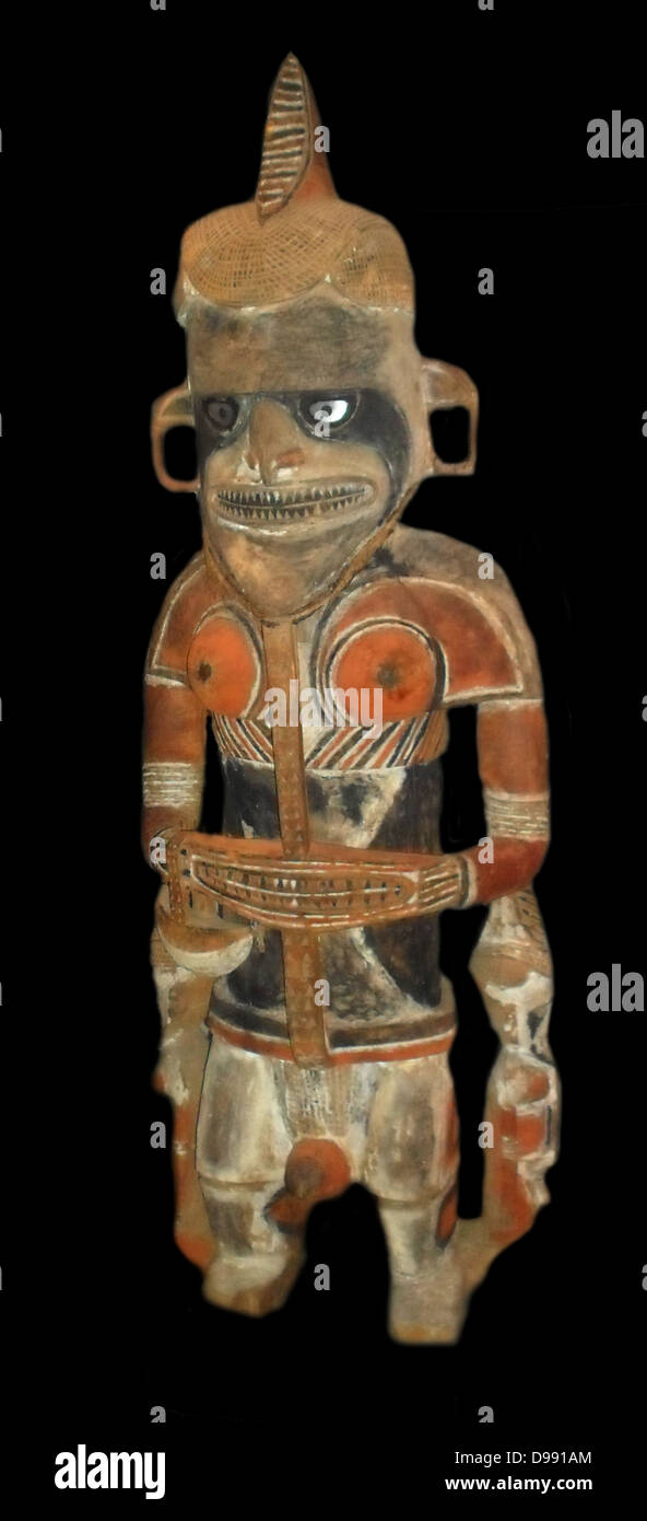 Androgynous ancestor figure, carved in wood from New ireland in Papua New Guinea. 19th Century.The figure possesses both female and male potency and fertility attributes. Stock Photo