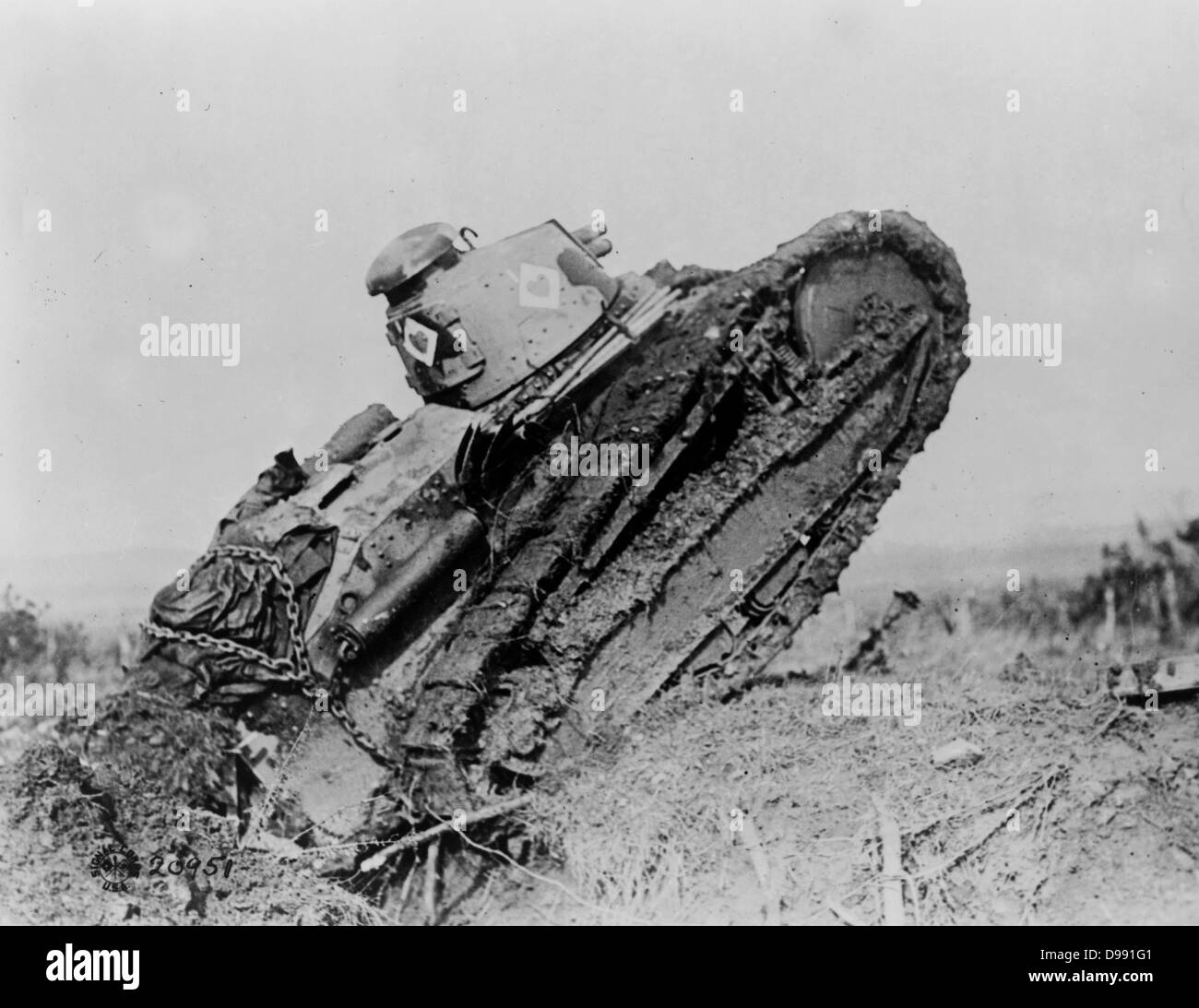 World War I 1914-1918: Tank ploughing its way through a trench and making towards the German line near Saint Michel, France. War Machine Armoured Vehicle Caterpillar Track Stock Photo