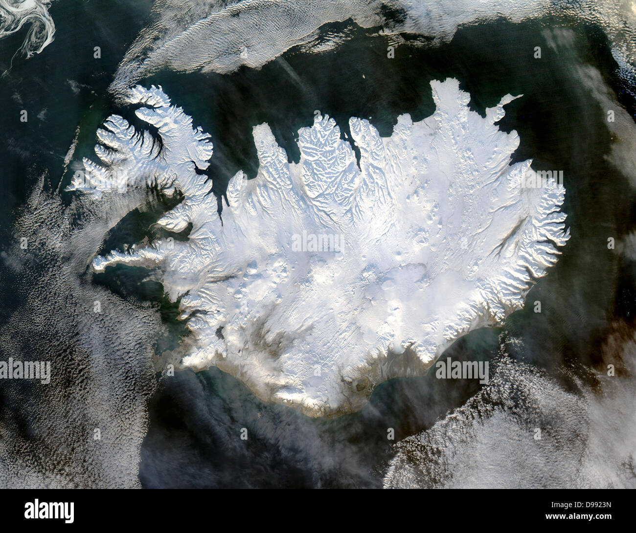 Satellite image of Iceland on 28 January 2004 showing it covered in a blanket of snow and ice which is obscuring the permanent glaciers and icecaps that exist year-round. Credit NASA. Science Winter Stock Photo