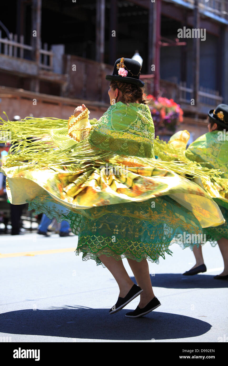 bolivian dancers in traditional costume swirling during Carnaval parade in Mission District, San Francisco, California, USA Stock Photo