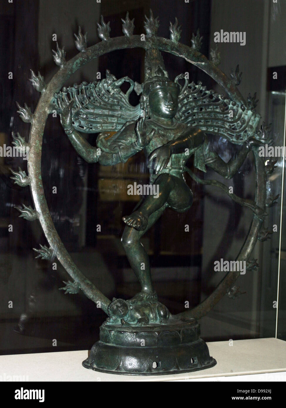 Hindu god Shiva appears as Nataraja (lord of the dance) dancing in a ring of fire. In his hair is a small representation of the goddess Ganga. Bronze figure of Nataraja, Tamil Nadu, southern India, Chola dynasty, c1100. Mythology Stock Photo