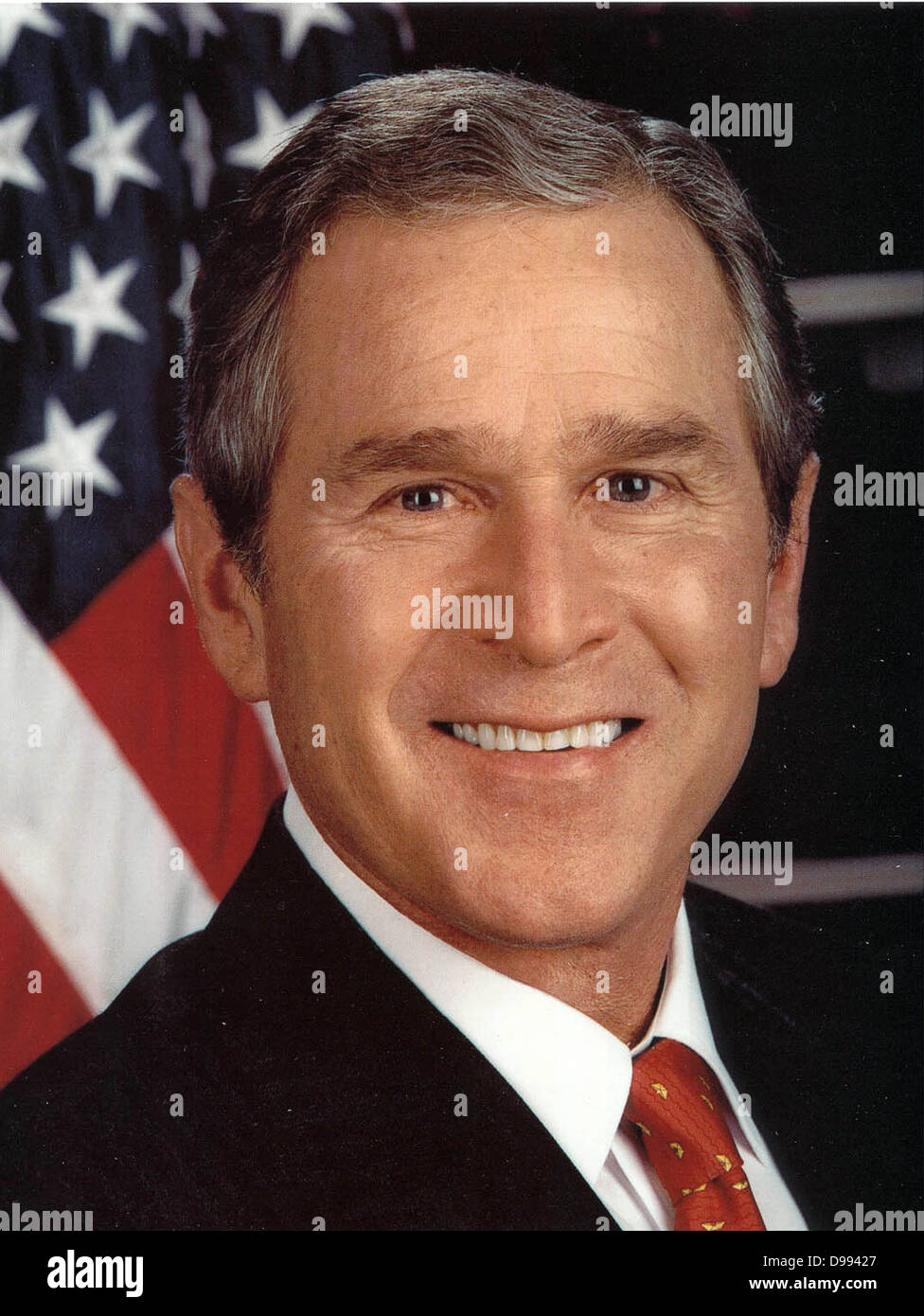 George Walker Bush (born 1946) 43rd President of the United States 2001-2009. 46th Governor of Texas 1995-2000. Head-and-shoulders portrait with stars-and-stripes in background. American Politician Republican Stock Photo