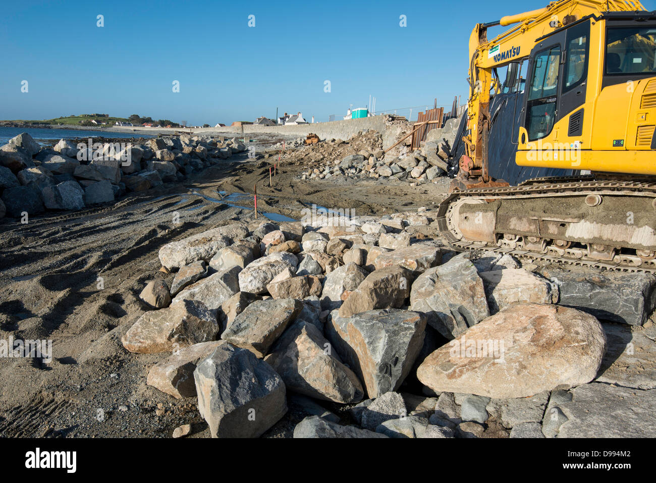 Repairs being made to a sea wall which was breached during a winter storm, at Perelle Bay in Guernsey, Channel Islands. Stock Photo