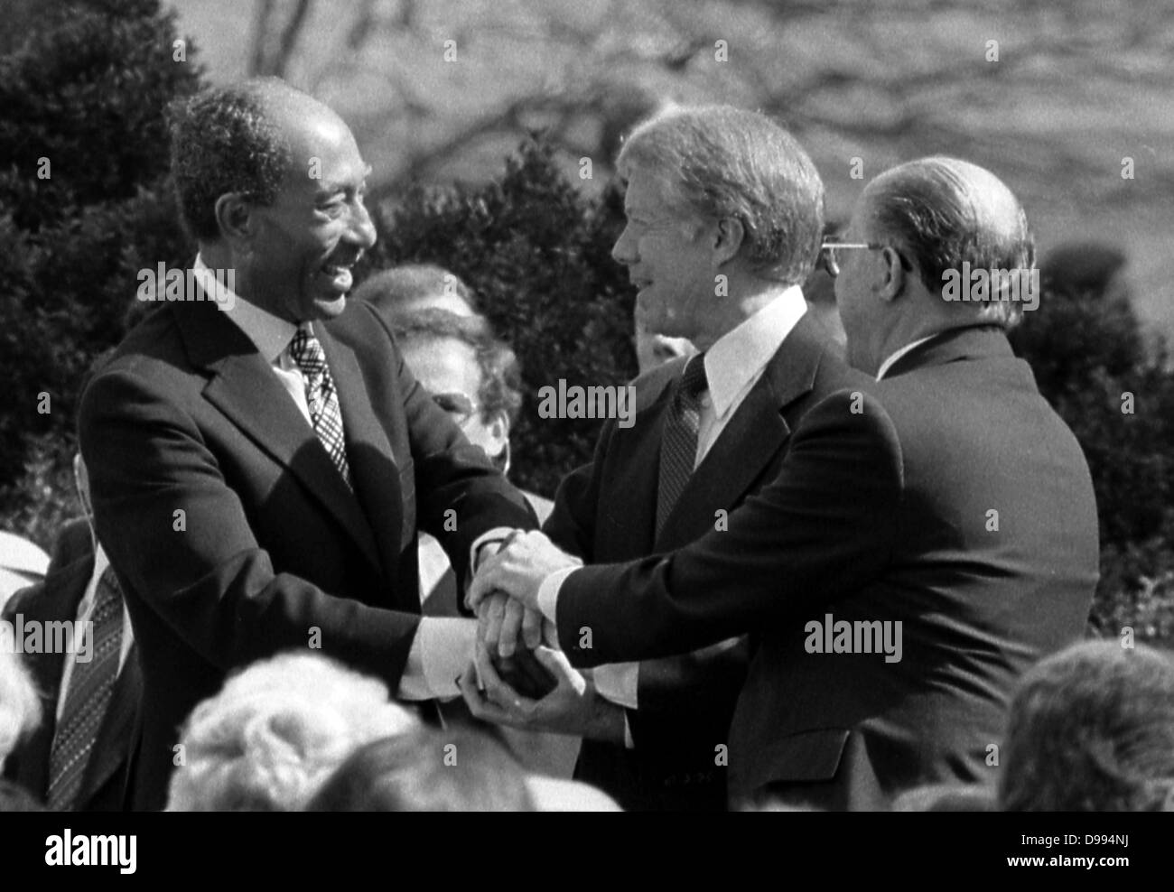 Egyptian President Anwar Sadat, US President Jimmy Carter and Israeli Prime Minister Menachem Begin shake hands at the time of the Peace treaty between Israel and Egypt in 1979 Stock Photo