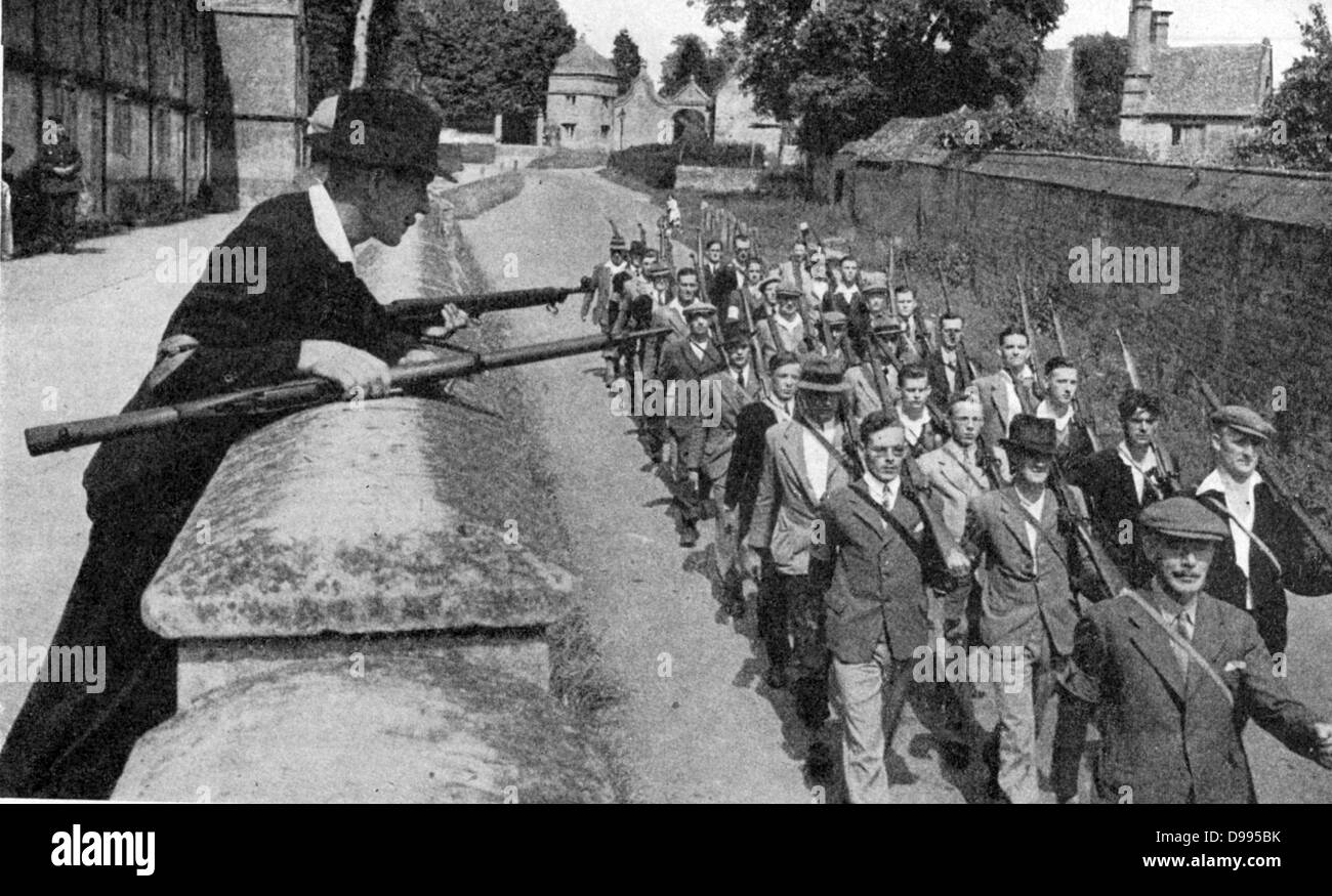 With German invasion threatening, Local Defence Volunteers (Home Guard) was created in Britain in May 1940 with men from 17 to 65. Home Guard on the march, Church Street, Chipping Campden, Gloucestershire, England. Stock Photo